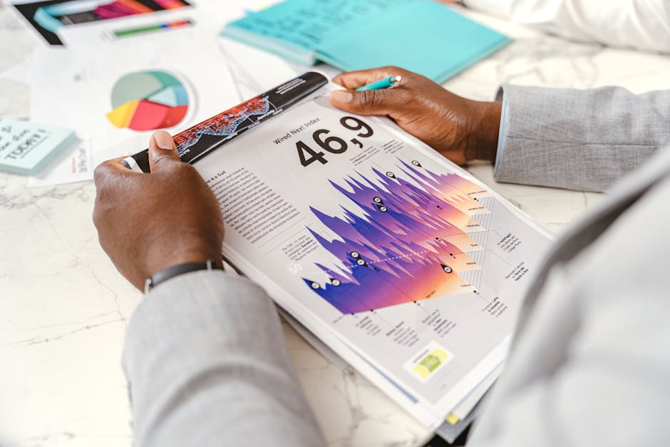 Close-up of a businessman analyzing colorful statistical data in an office setting.